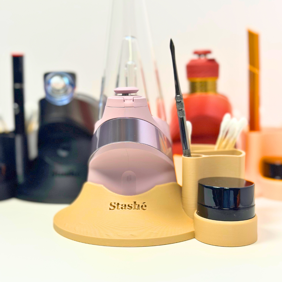 Puffco Peak clicked into a stashe base holding a jar, cotton swabs, and concentrate tool.